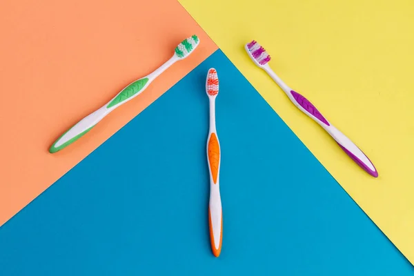 Top View Set Three Tooth Brushes Vivid Multicolored Background — Stock Photo, Image