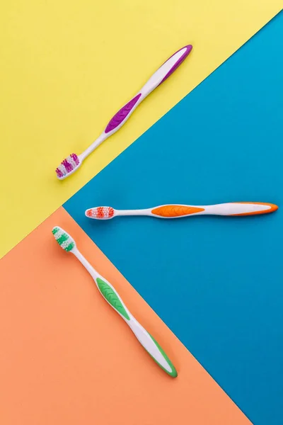 Vertical Shot Top View Three Colorful Toothbrushes Vivid Multicolored Background — Stock Photo, Image