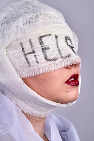 Woman with bandage on her head and eyes. Vertical shot close up.