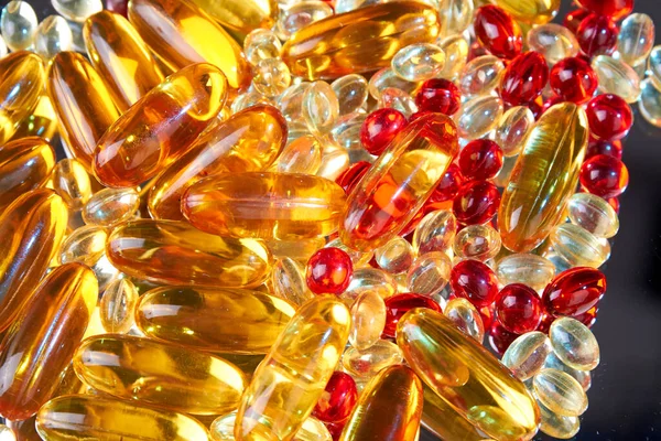 Close up pile of golden capsules of vitamin D3. Biologically active substances.