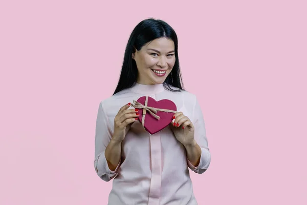 Счастливая Веселая Молодая Азиатка Подарочной Коробкой Форме Сердца Изолированный Розовом — стоковое фото