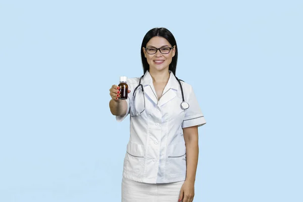 Portrait Young Female Asian Doctor Giving Medicine Bottle Isolated Blue — Stock Photo, Image