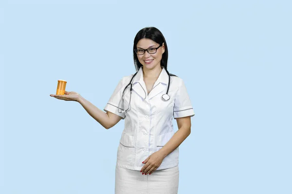 Young Female Doctor Glasses Showing Orange Medicine Bottle Her Palm — Stock Photo, Image