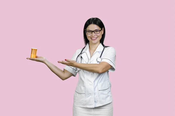 Young Female Doctor Advertising Orange Medicine Bottle Her Palm Isolated — Stock Photo, Image