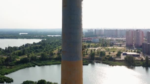 从工业厂房烟囱上的无人飞机上看到的景象 以城市河流和住宅区为背景 — 图库视频影像