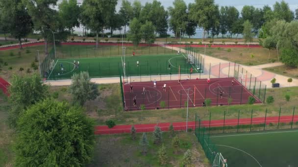 公園内の野外サッカー場やバスケットボール場でのトレーニング 空中ドローンビュー — ストック動画
