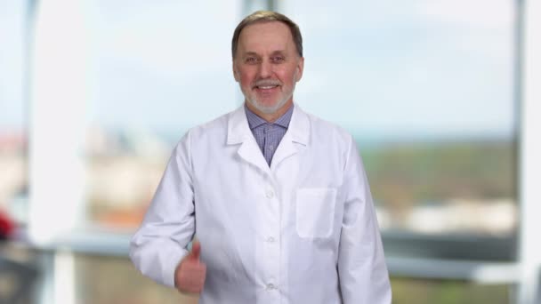 Portrait Happy Mature Caucasian Smiling Doctor Shows Both Thumbs Blurred — Stock Video