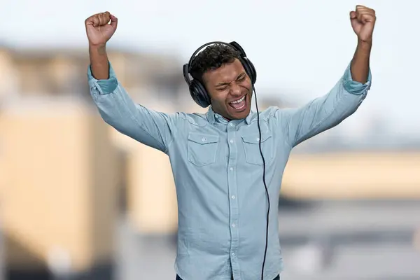 Energetic Young Man Listening Music Headphones Raised His Hands Positive — Stock Photo, Image