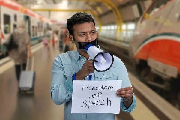 Man Taped Mouth Holding Megaphone Blurred Metro Subway Station Background — Stock Photo, Image