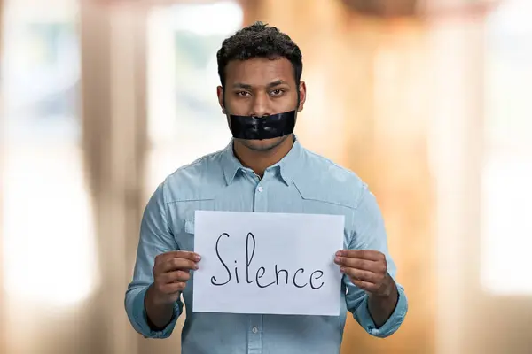 Dark Skinned Censored Man Holding Paper Banner Inscription Silcence Interior — Stock Photo, Image