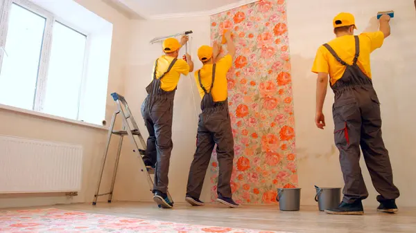 Brigade Craftsmen Making Renovation Specialists Wallpapering House — Stock Photo, Image
