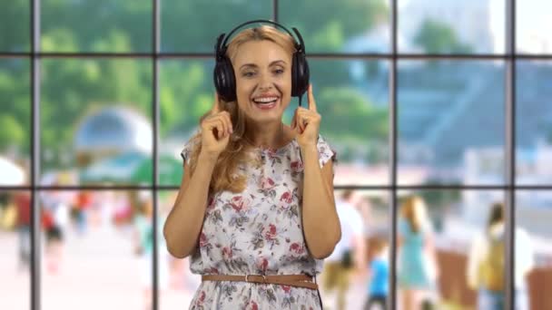 Happy Blonde Woman Enjoying Music Headphones Indoor Window City Street — Stock Video