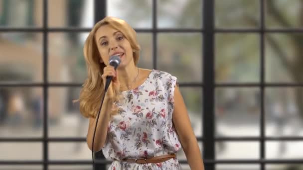 Portrait Blond Woman Singing Microphone Indoors Checkered Window Background — Stock Video