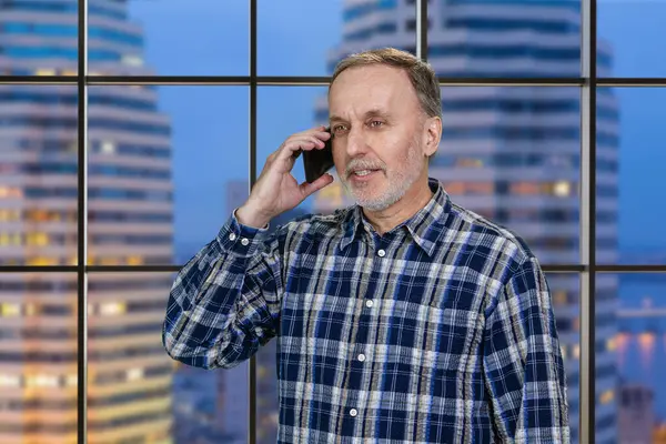 Handsome Mature Businessman Talking Mobile Phone Standing Office Checkered Window ロイヤリティフリーのストック写真