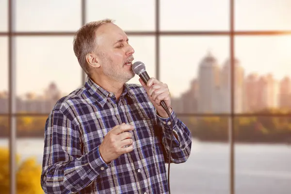Portrait Mature Man Singing Giving Speech Microphone Indoors Checkered Windows Stock Picture