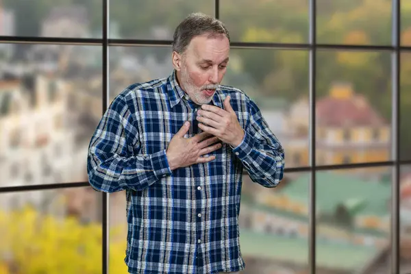 Portrait Mature Man Coughing Standing Indoors Windows Background Cityscape View Stock Photo