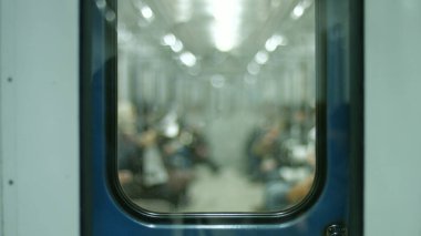 Passengers traveling in a subway car. People go from work in the wagon. Time to peak. Underground subway. clipart