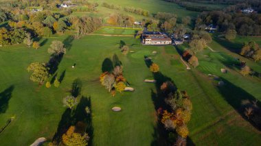 Aerial View of Mullingar golf course in Ireland on a sunny Autumn day, with long shadows and colors of autumn.