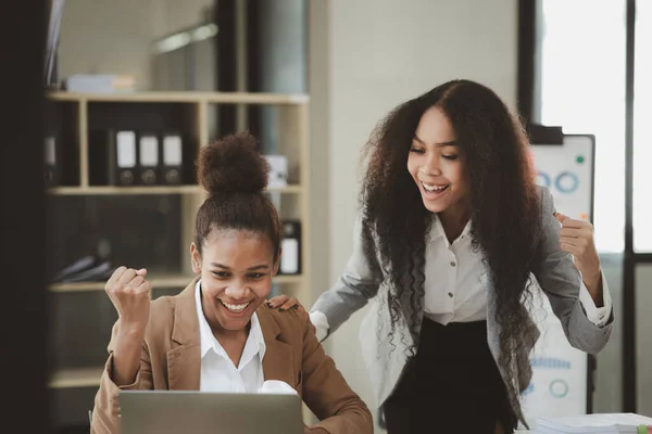 stock image Two American women are working together in the office of a startup company. They are having a brainstorming and planning meeting in a joint department, women leading the way. Concept of women's work.