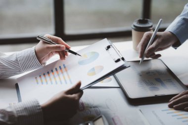 The sales department is having a monthly summary meeting to bring it to the department manager, they are verifying the correctness of the documents that are prepared before bringing in to the manager