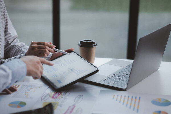 A meeting of two businessmen brainstorming a marketing plan and analyzing sales to come up with strategies for marketing to increase the company's sales. Business administration concept.