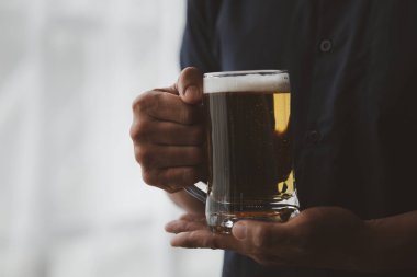 Elinde bir bardak brendi tutan bir adam, bir barda brendi içiyor, alkol içiyor araba kullanma yeteneğine zarar veriyor ve sağlığa zarar verebilir. Alkol konsepti.