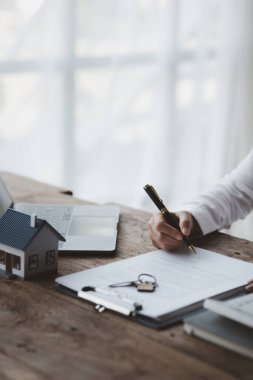 Ev satış temsilcileri ve satış temsilcileri projedeki evleri görmek isteyen müşterilere projede konut detaylarını tavsiye ediyorlar. Gayrimenkul ticareti.