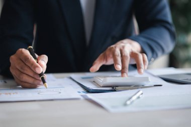 Businessman working, businessman looking at business documents and checking company finances, young startup company executive. Startup business management concept.