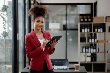 American woman in the office of a startup company, she is a company employee, young generation operations run the company with the concept of the new generation. Company management concept