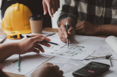 Architects and engineers are working together to edit the draft house plan that was designed after it was presented to the client and partially revised the design. Interior design and decoration ideas