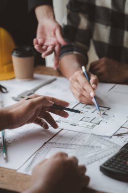 Architects and engineers are working together to edit the draft house plan that was designed after it was presented to the client and partially revised the design. Interior design and decoration ideas