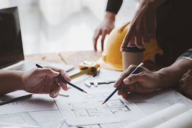 Architects and engineers are working together to edit the draft house plan that was designed after it was presented to the client and partially revised the design. Interior design and decoration ideas