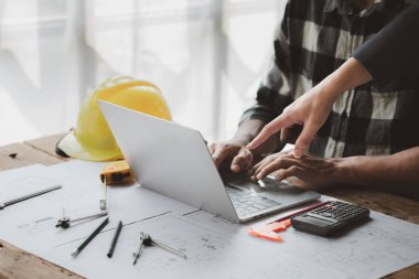 Architects and engineers are working together to edit the draft house plan that was designed after it was presented to the client and partially revised the design. Interior design and decoration ideas