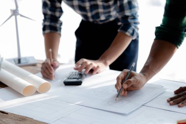 Architects and engineers are working together to edit the draft house plan that was designed after it was presented to the client and partially revised the design. Interior design and decoration ideas