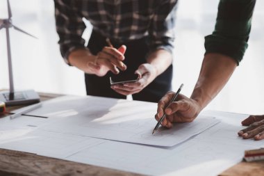 Architects and engineers are working together to edit the draft house plan that was designed after it was presented to the client and partially revised the design. Interior design and decoration ideas