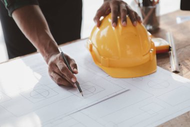 Architects and engineers are working together to edit the draft house plan that was designed after it was presented to the client and partially revised the design. Interior design and decoration ideas