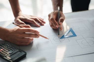 Architects and engineers are working together to edit the draft house plan that was designed after it was presented to the client and partially revised the design. Interior design and decoration ideas