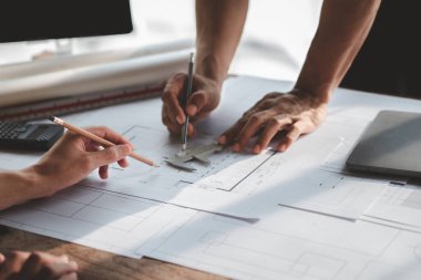 Architects and engineers are working together to edit the draft house plan that was designed after it was presented to the client and partially revised the design. Interior design and decoration ideas