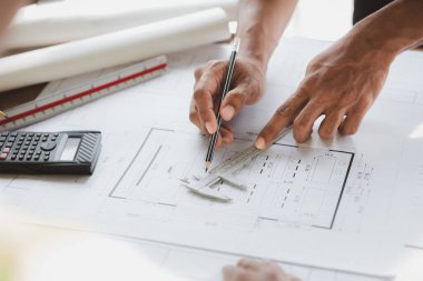 Architects and engineers are working together to edit the draft house plan that was designed after it was presented to the client and partially revised the design. Interior design and decoration ideas