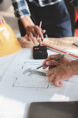 Architects and engineers are working together to edit the draft house plan that was designed after it was presented to the client and partially revised the design. Interior design and decoration ideas