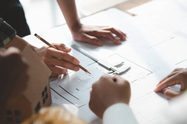 Architects and engineers are working together to edit the draft house plan that was designed after it was presented to the client and partially revised the design. Interior design and decoration ideas