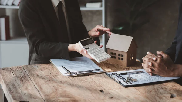 House sales representatives, sales representatives recommend housing details in the project to customers who are interested in viewing the houses in the project. Real estate trading concept.