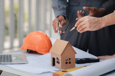 Architects and engineers are working together to edit the draft house plan that was designed after it was presented to the client and partially revised the design. Interior design and decoration ideas