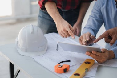 Architects and engineers are working together to edit the draft house plan that was designed after it was presented to the client and partially revised the design. Interior design and decoration ideas