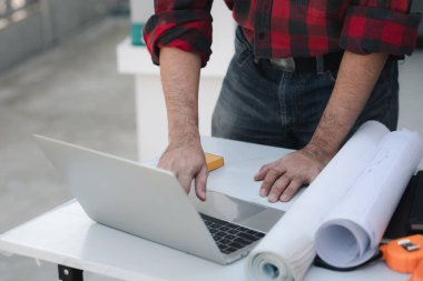 Architects and engineers are working together to edit the draft house plan that was designed after it was presented to the client and partially revised the design. Interior design and decoration ideas