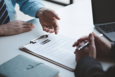 A person attends a job interview with a manager to join a company, he holds a resume and interview with information introducing himself and his ability to work. Job application concept.