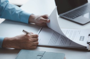 A person attends a job interview with a manager to join a company, he holds a resume and interview with information introducing himself and his ability to work. Job application concept.