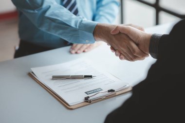 A person attends a job interview with a manager to join a company, he holds a resume and interview with information introducing himself and his ability to work. Job application concept.