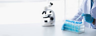 Lab practitioner working on chemical research for chemical reactions, does a chemical experiment and examines a patient's blood sample. Medicine and research concept.