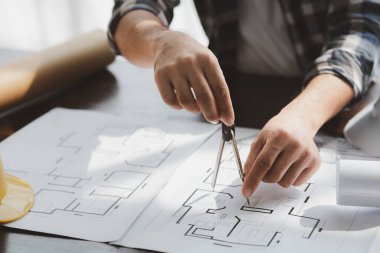 Architects and engineers are working together to edit the draft house plan that was designed after it was presented to the client and partially revised the design. Interior design and decoration ideas